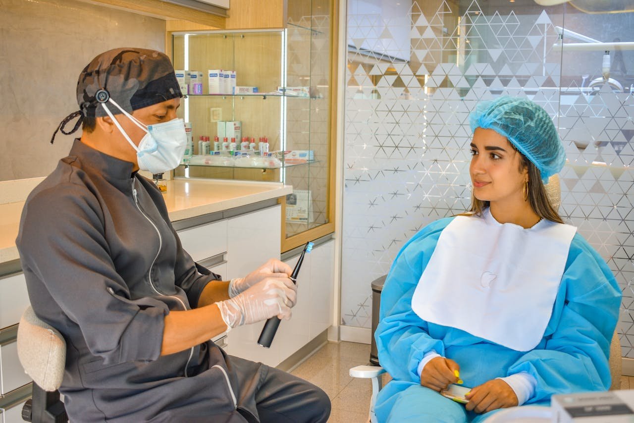 Professional dentist consulting with a patient in a modern dental clinic setting.